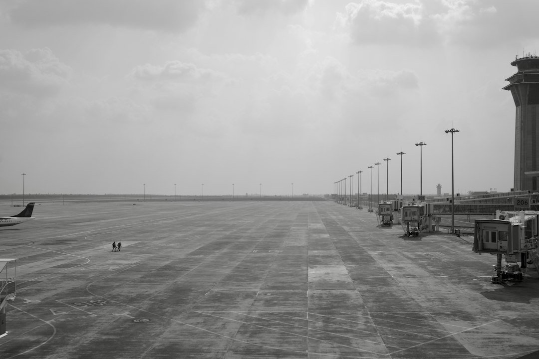 Airport tarmac with jet bridges and an air traffic control tower