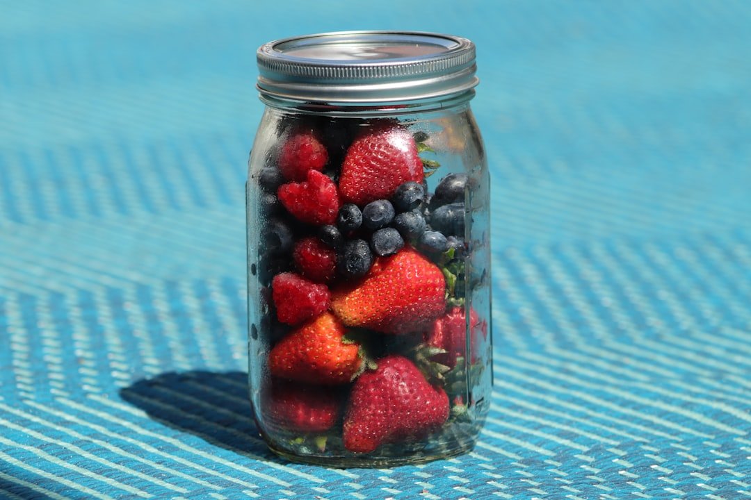 Jar of overnight oats layered with strawberries, blueberries and raspberries