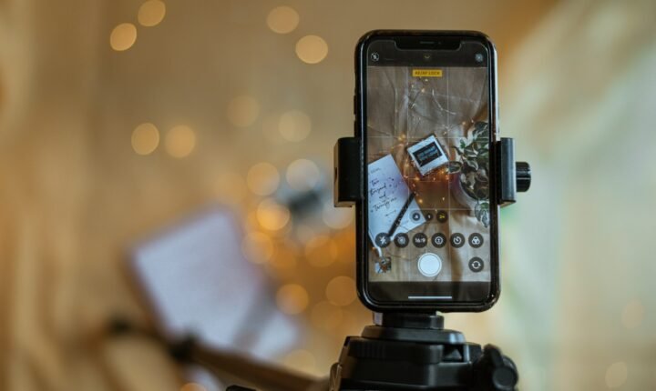Camera, tripod and smartphone illustrating production of a YouTube Shorts series