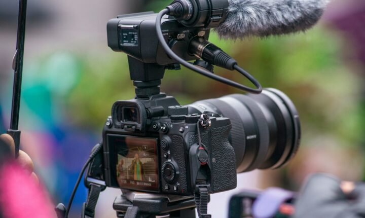 Camera recording a speaker, illustrating YouTube live-streaming tools
