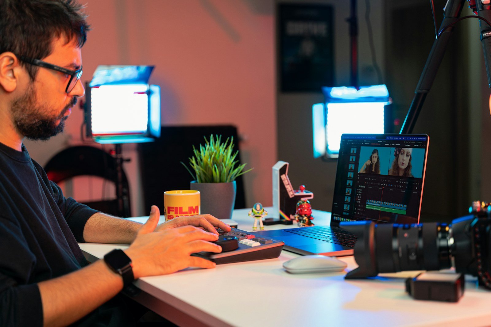 Filmmaker editing video on a laptop at a desk, illustrating creator workflows discussed in YouTube Studio's 2026 update
