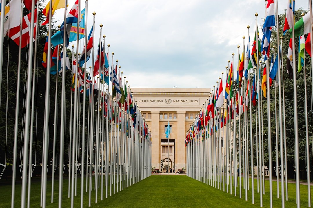 International flags outside a conference venue, illustrating diplomatic talks on AI safety