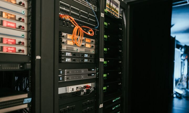 Rows of server racks illustrating Nscale's AI data-centre infrastructure business