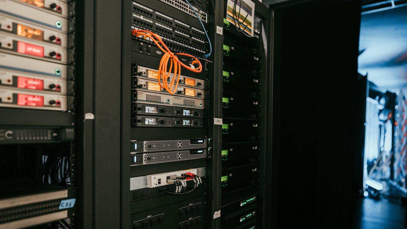 Rows of server racks illustrating Nscale's AI data-centre infrastructure business