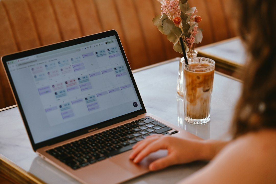 A person using a laptop with a calendar interface while planning work