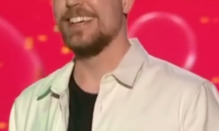 MrBeast holding a Nickelodeon Kids’ Choice Award onstage in 2023