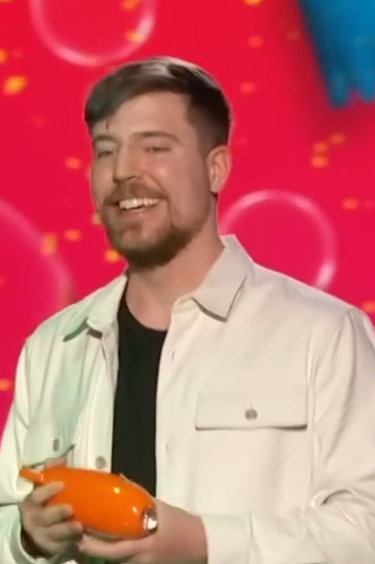 MrBeast holding a Nickelodeon Kids’ Choice Award onstage in 2023