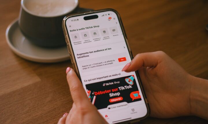 A person using a smartphone displaying TikTok Shop