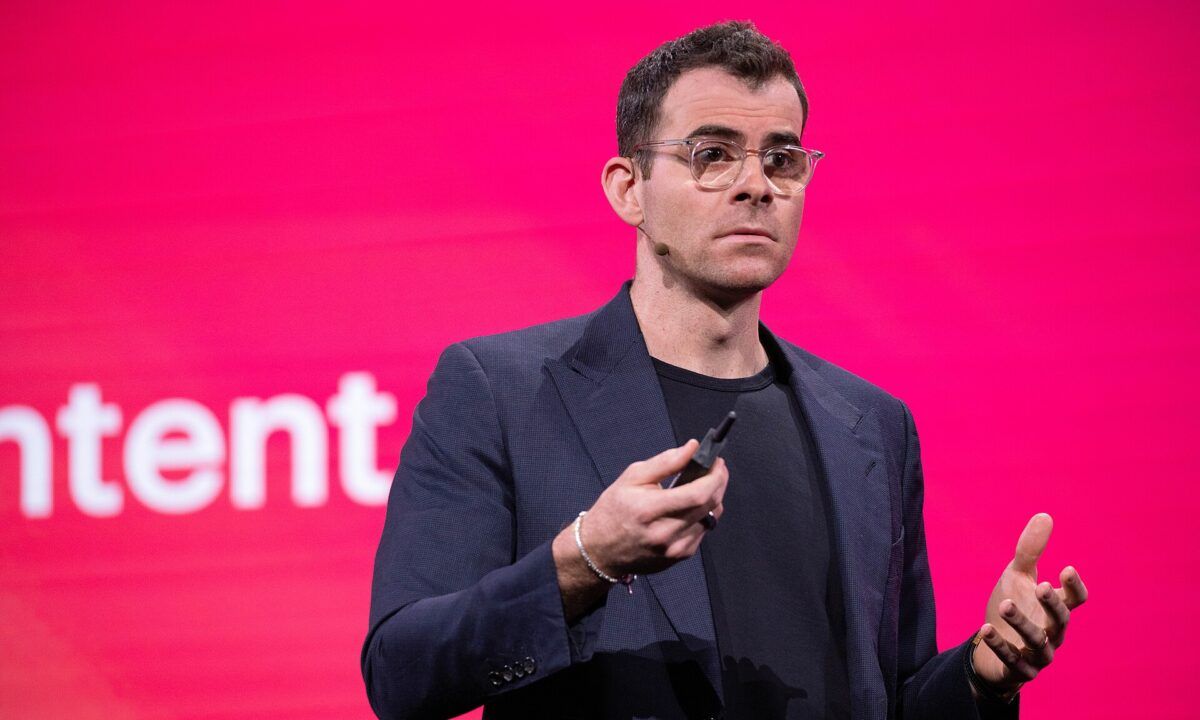 Head of Instagram Adam Mosseri speaking on stage in front of a pink screen