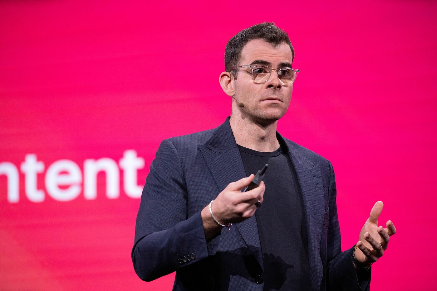 Head of Instagram Adam Mosseri speaking on stage in front of a pink screen