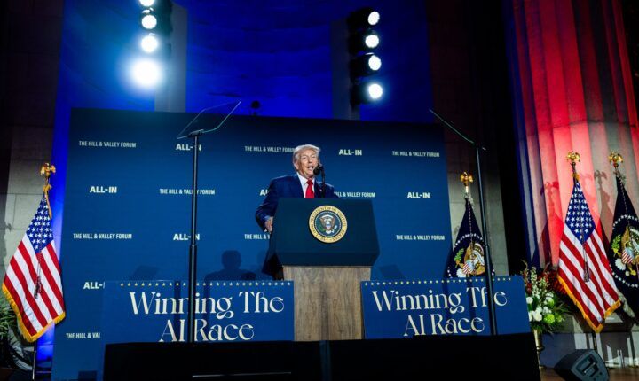 Donald Trump speaks under Winning the AI Race signs, months before his Super Intelligence order