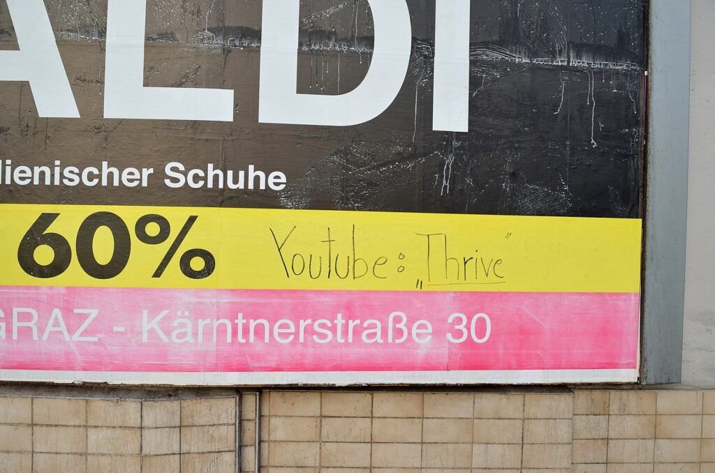 YouTube spam termination rules cover off-platform promotion like this handwritten YouTube link scrawled on a billboard