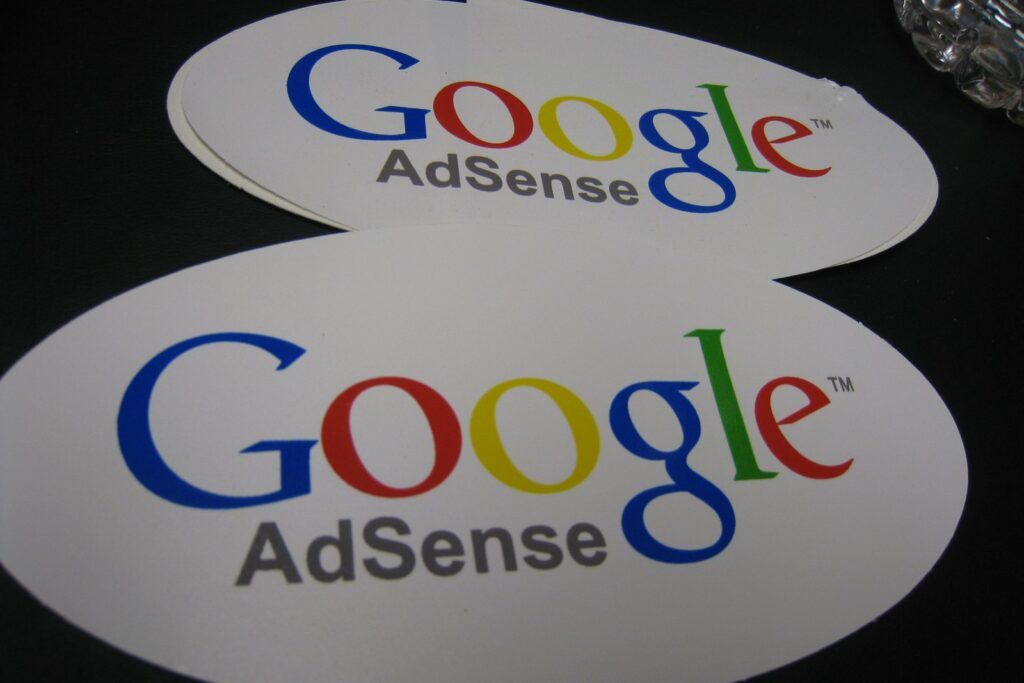 Google AdSense logo stickers; AdSense for YouTube handles the YouTube payment threshold