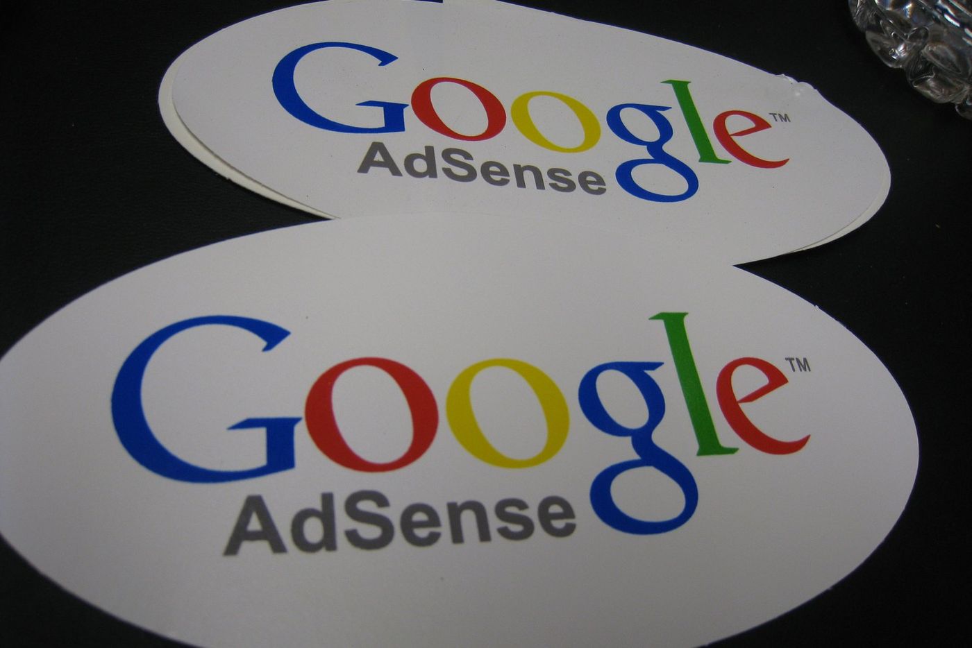 Google AdSense logo stickers; AdSense for YouTube handles the YouTube payment threshold
